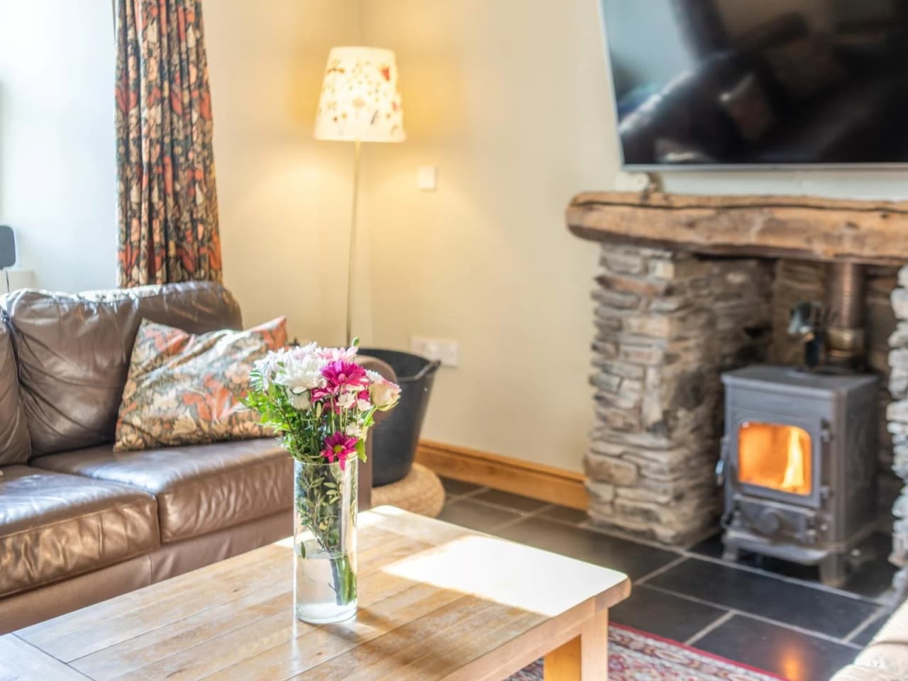 A close up shot of the lounge coffee table and roaring fire