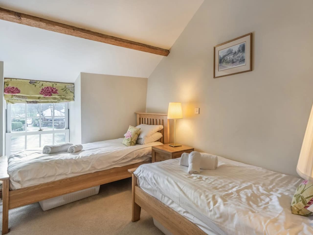 The third bedroom with twin single beds and a view down the road out of the window