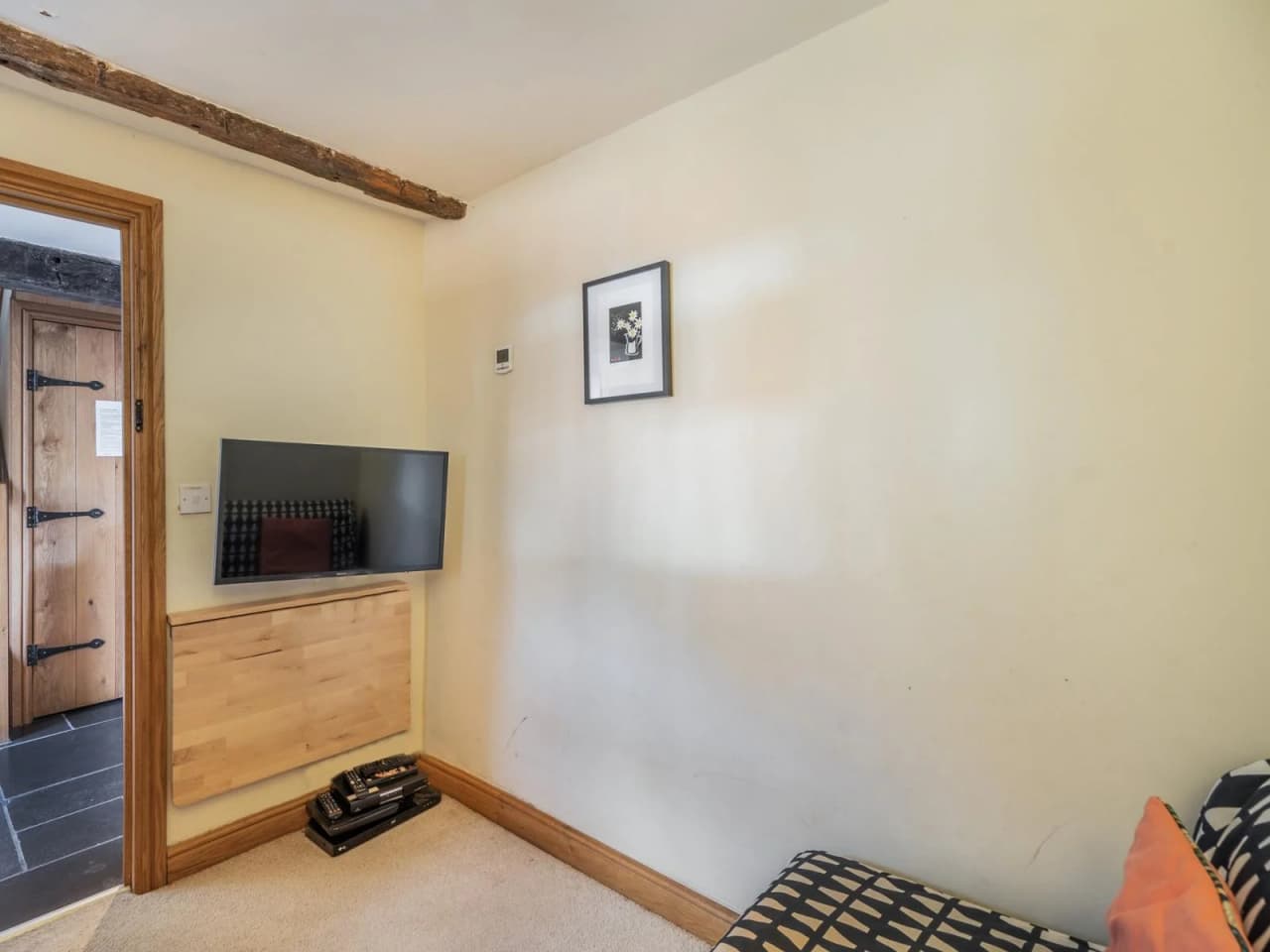 The view from inside the snug room looking back out of the room and the tv on the wall